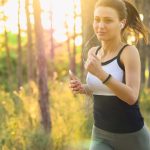 Woman using light technology patch jogging.